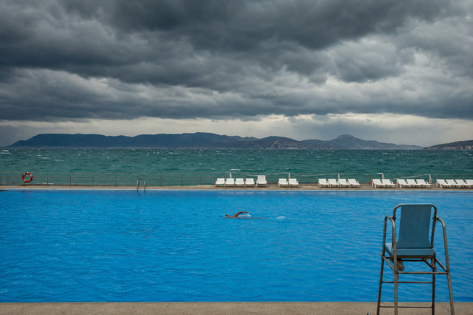 Dark cloudy sky over water symbolizing heavy outdoor air conditions